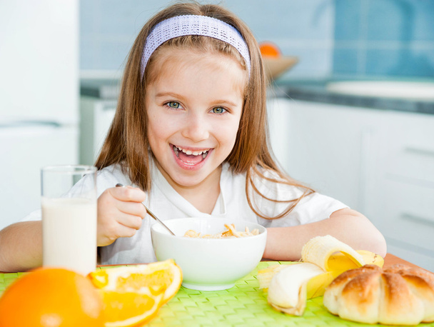 Little girl eating breakfast - Photo, image