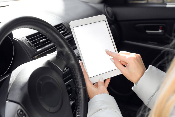 Female driver using tablet computer for navigation, closeup - Fotó, kép