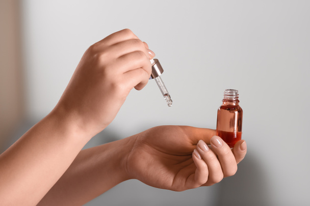 Woman applying serum onto her hand, closeup - Foto, Imagen
