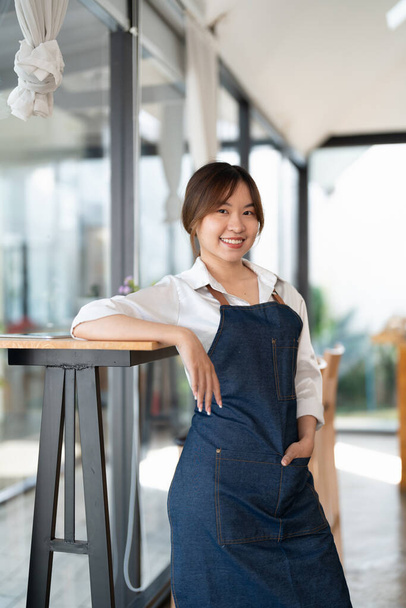Portrait of woman barista startup successful small Asian business owner in coffee shop.Asian woman barista cafe owner. SME entrepreneur seller business concept - Φωτογραφία, εικόνα