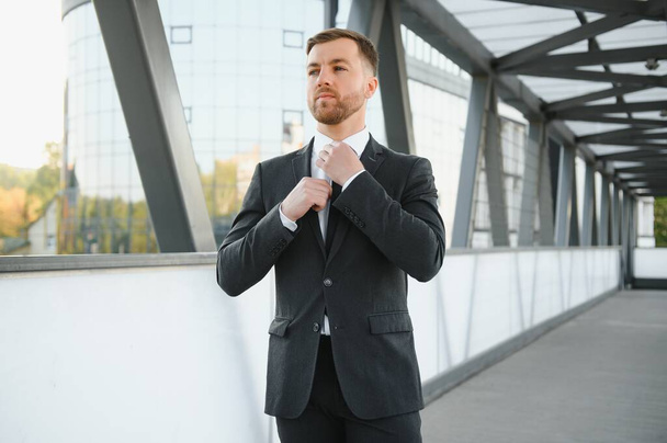 Handsome male model posing wearing a back suit - Fotoğraf, Görsel