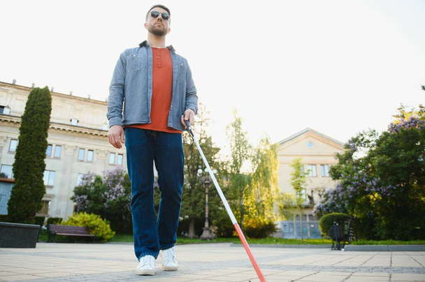 Blind Man Walking On Sidewalk Holding Stick. - Photo, image
