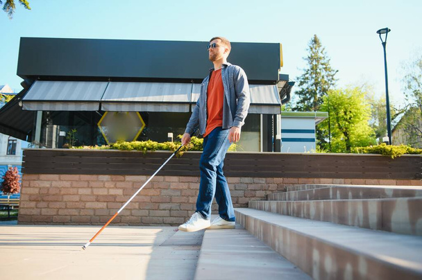 Blind Man Walking On Sidewalk Holding Stick. - Zdjęcie, obraz
