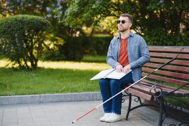 blind man sitting on a bench. - Фото, зображення