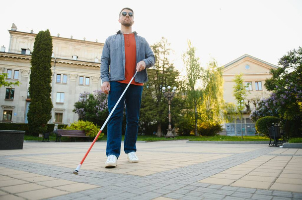Blind Man Walking On Sidewalk Holding Stick. - Foto, Bild
