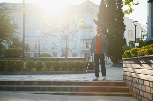 Blind Man Walking On Sidewalk Holding Stick. - Foto, Bild