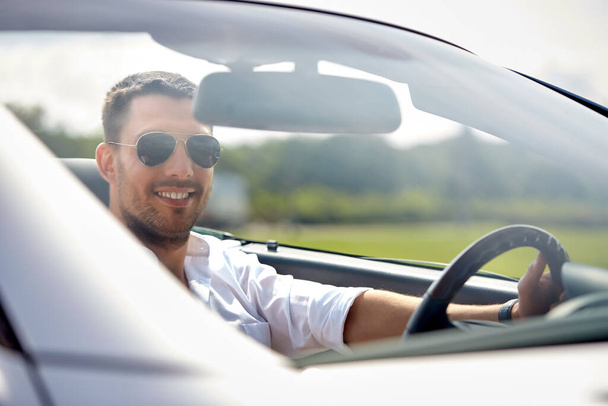 happy man in sunglasses driving convertible car - Photo, Image