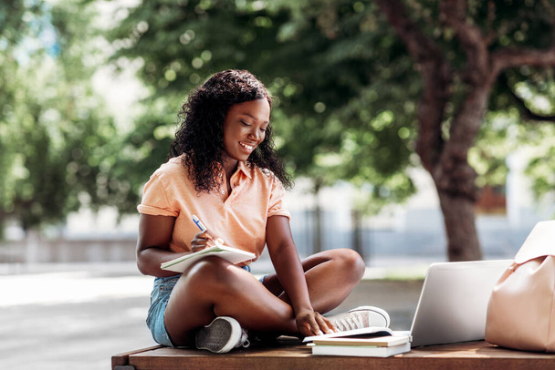 african student girl with laptop and books in city - Foto, Imagen