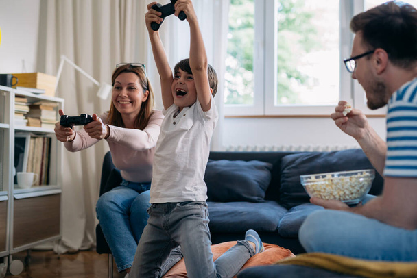 mother playing video games with her son at home - Foto, Imagem