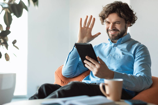 Business man using tablet waving hand making video call - Фото, зображення