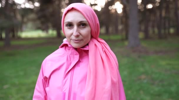 woman in the field on her back with a pink headscarf, International Breast Cancer Day, fighter survivor - Footage, Video