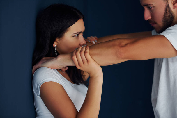 Violent aggressive young man beats his girlfriend at home. - Valokuva, kuva