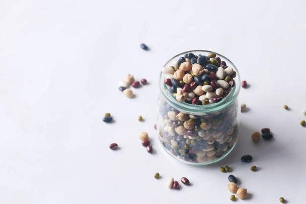 mixed beans in a glass jar on table  - Foto, afbeelding