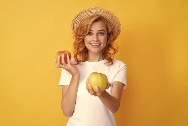 cheerful redhead girl in straw hat sharing apple, detox - Photo, Image