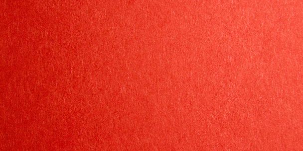 red background with thick paper texture. uneven lighting. Banner for insertion into site. Place for text cope space. Horizontal image. - Photo, Image