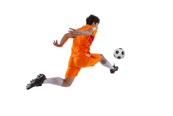 Professional football, soccer player in motion isolated on white studio background. Concept of sport, match, active lifestyle, goal and hobby - Foto, afbeelding