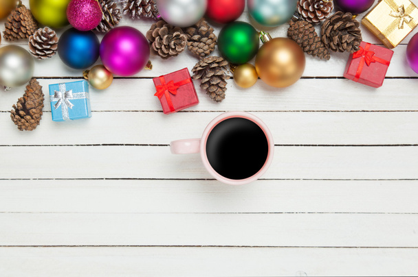 Cup of coffee and christmas toys on white table. - Photo, Image