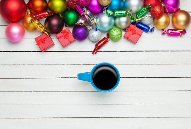 Coffee cup and christmas toys on white background. - Photo, Image