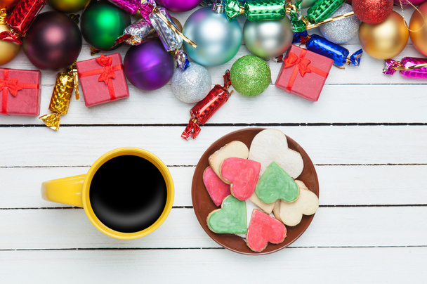 Cup of coffee and cookie with christmas toys on whte background. - Photo, Image