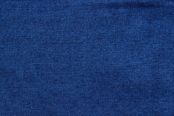Texture of blue denim close-up. Modern high-quality material for clothes. - Zdjęcie, obraz