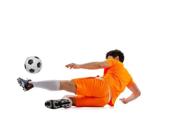 Professional football, soccer player in motion isolated on white studio background. Concept of sport, match, active lifestyle, goal and hobby. Wide angle view - Foto, imagen