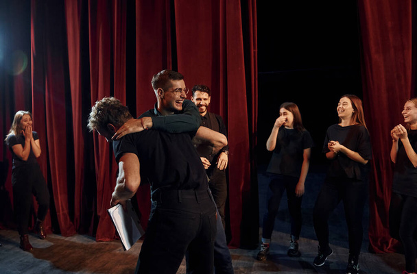 Fight scene. Group of actors in dark colored clothes on rehearsal in the theater. - Foto, Imagem