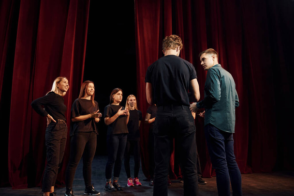 Group of actors in dark colored clothes on rehearsal in the theater. - Foto, immagini