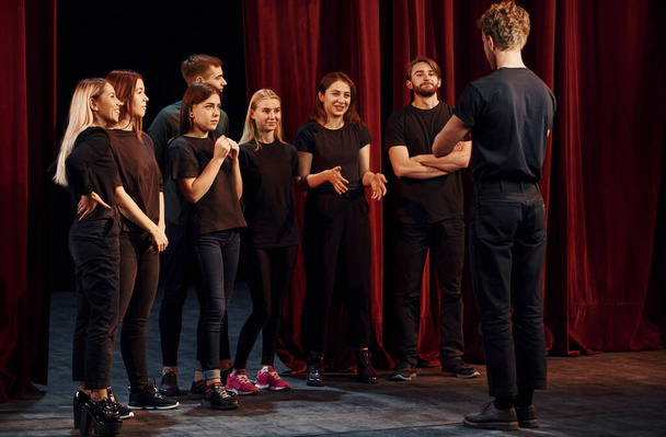 Group of actors in dark colored clothes on rehearsal in the theater. - Photo, Image