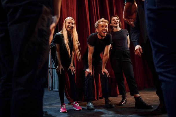 Practice in progress. Group of actors in dark colored clothes on rehearsal in the theater. - Valokuva, kuva