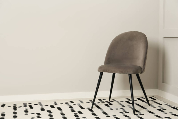 Stylish grey chair near light wall in room. Space for text - Foto, immagini