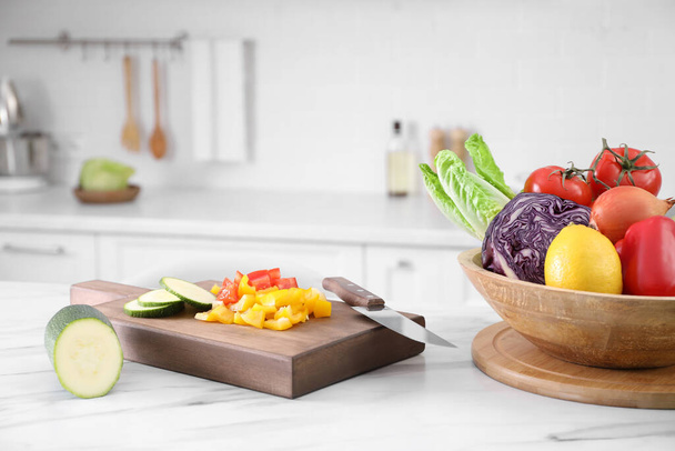 Different raw vegetables on white marble table in kitchen - Photo, Image