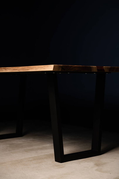 lacquered table made of natural wood with metal legs - Foto, afbeelding