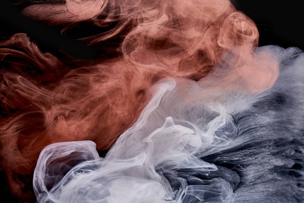 Orange white smoke on black ink background, colorful fog, abstract swirling touch ocean sea, acrylic paint pigment underwater - Foto, Imagem