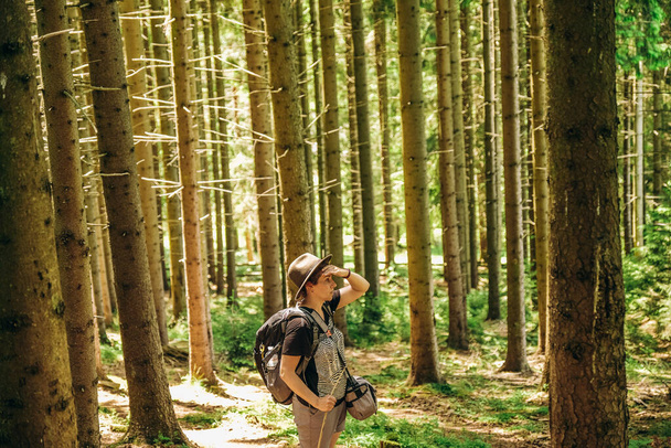 Літня поїздка в гори. Жінка гуляє в лісі влітку. Походи в гори. Активний відпочинок влітку
. - Фото, зображення