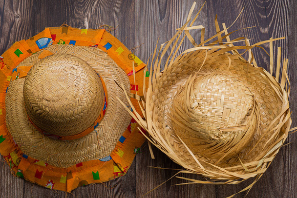 Straw hat for June festival seen from above on wooden background. - Φωτογραφία, εικόνα