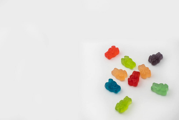 Colorful set of CBD infused medicinal candy gummies used for healing on a plain white background - Photo, image