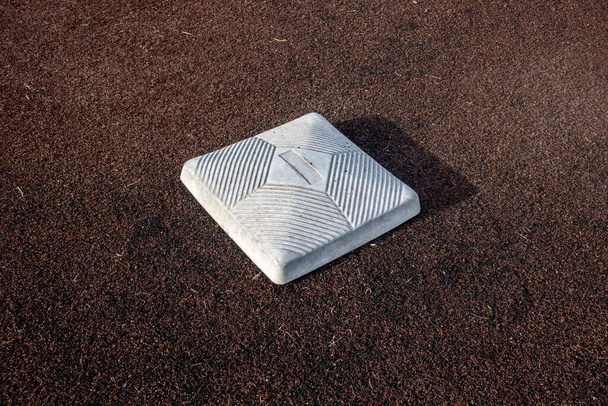 Top down, close up view of a base on a clean baseball field on a bright, sunny day - Fotografie, Obrázek