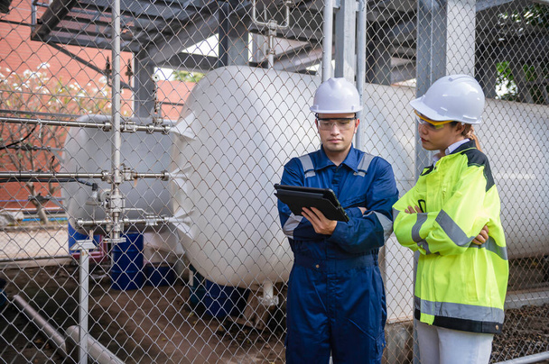 Engineers work place to keep liquid helium,preventive maintenance schedule checking,Thailand people,Technicians and engineers discuss work together. - Photo, Image