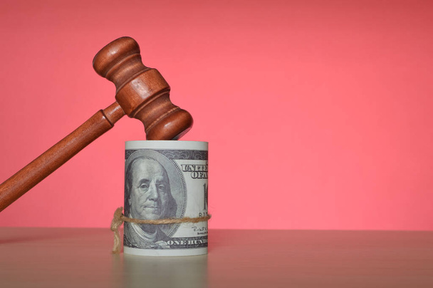 Judge gavel and money banknotes isolated on a red background - Photo, Image