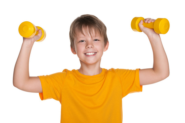 Cheerful boy with dumbbells do exercises - Foto, Imagen
