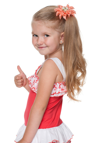 Little girl with her thumb up looks back - Фото, зображення