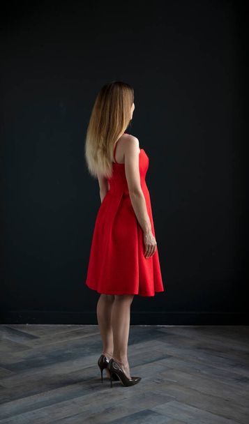 portrait of beautiful young woman on dark background - Фото, изображение
