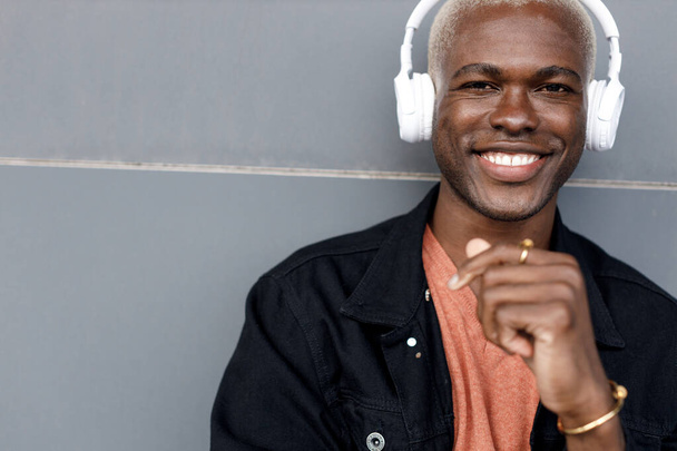 closeup portrait of Afro American man with headphones outdoor  - Фото, изображение