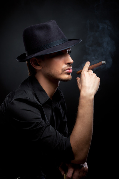 Gangster look. Man with hat and cigar. - 写真・画像