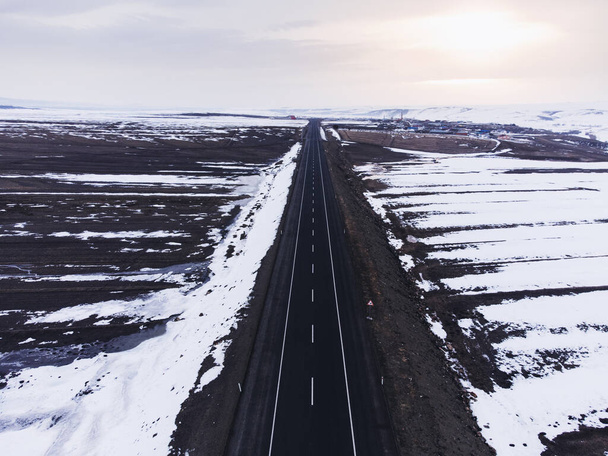 Aerial view of a road with one lane and snow in winter. - Foto, Imagem