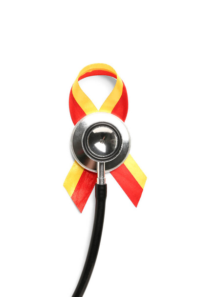 Awareness ribbon with stethoscope on white background. Hepatitis concept - Photo, Image