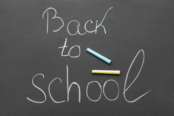 Text BACK TO SCHOOL with chalks on blackboard - Foto, imagen