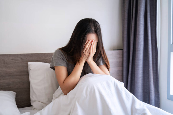 Lonely young woman feeling depressed and stressed sitting in the bedroom, Negative emotion and mental health concept - Photo, Image
