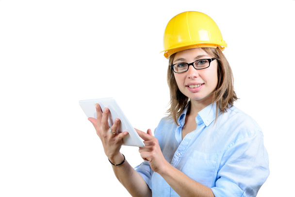 young female architect with a yellow helmet and digital tablet - Фото, изображение