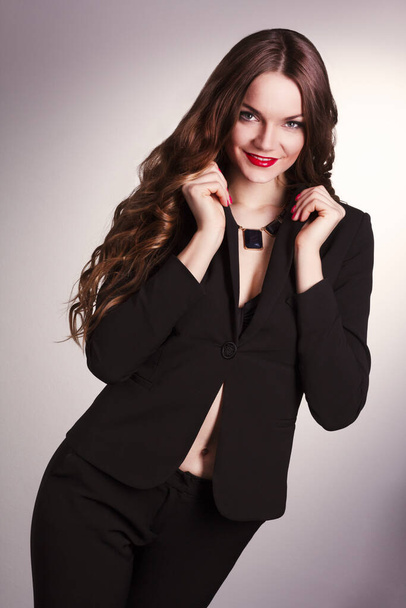 Beautiful brunette with a modern clothing posing on white background. - Zdjęcie, obraz
